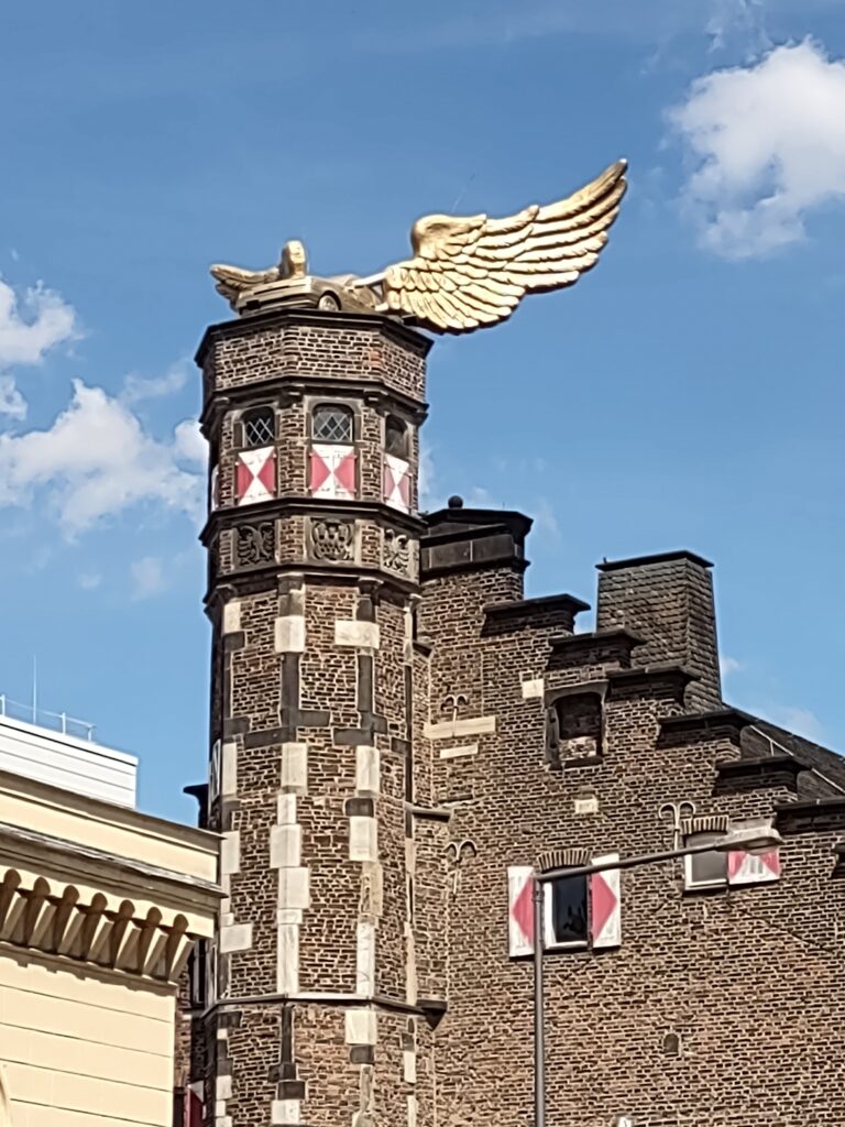 Car with wing on a building in Cologne